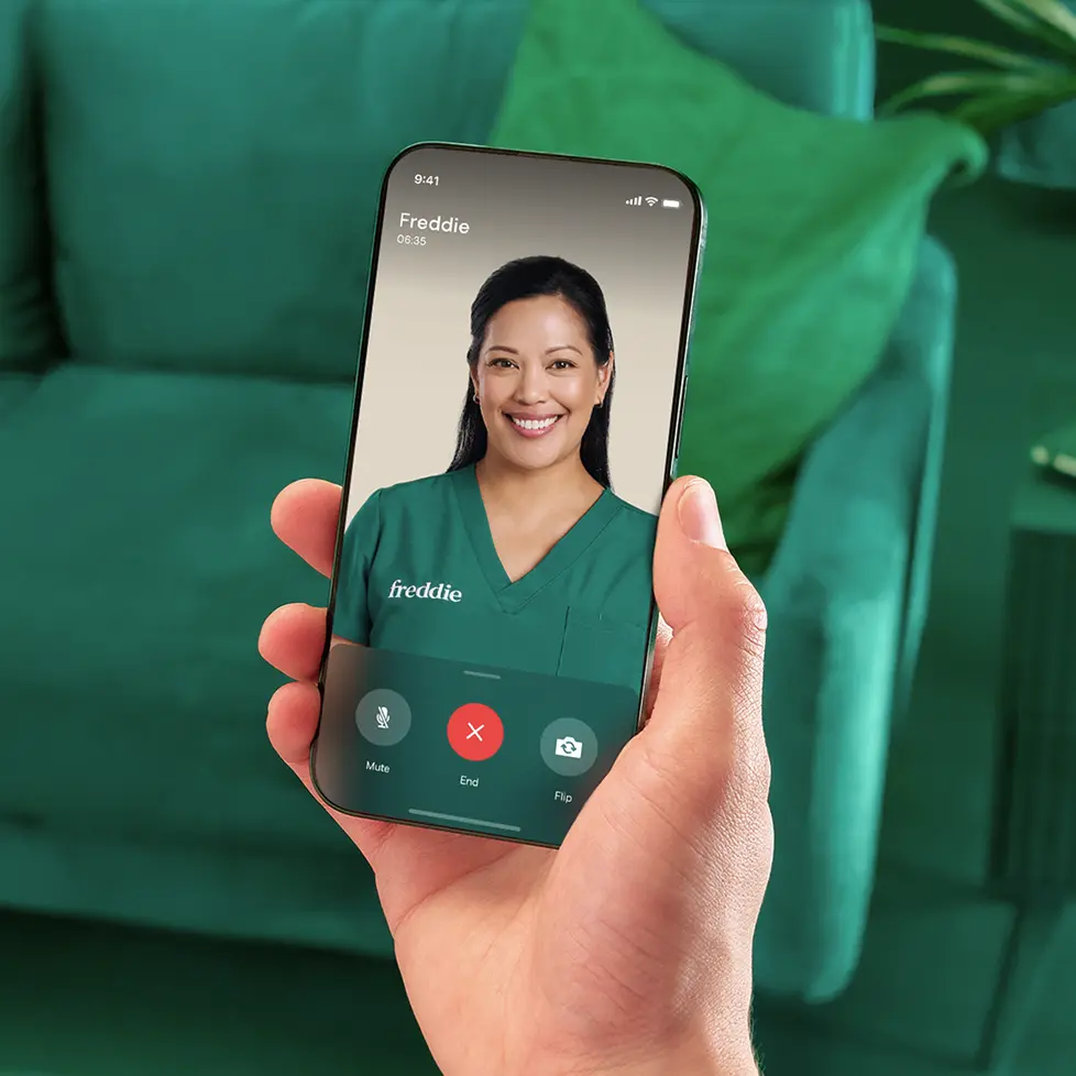 Smiling clinician in green scrubs on a video call